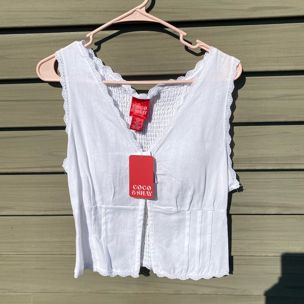 Coco & Shay white lace trimmed tank top with eyelit closure in front.